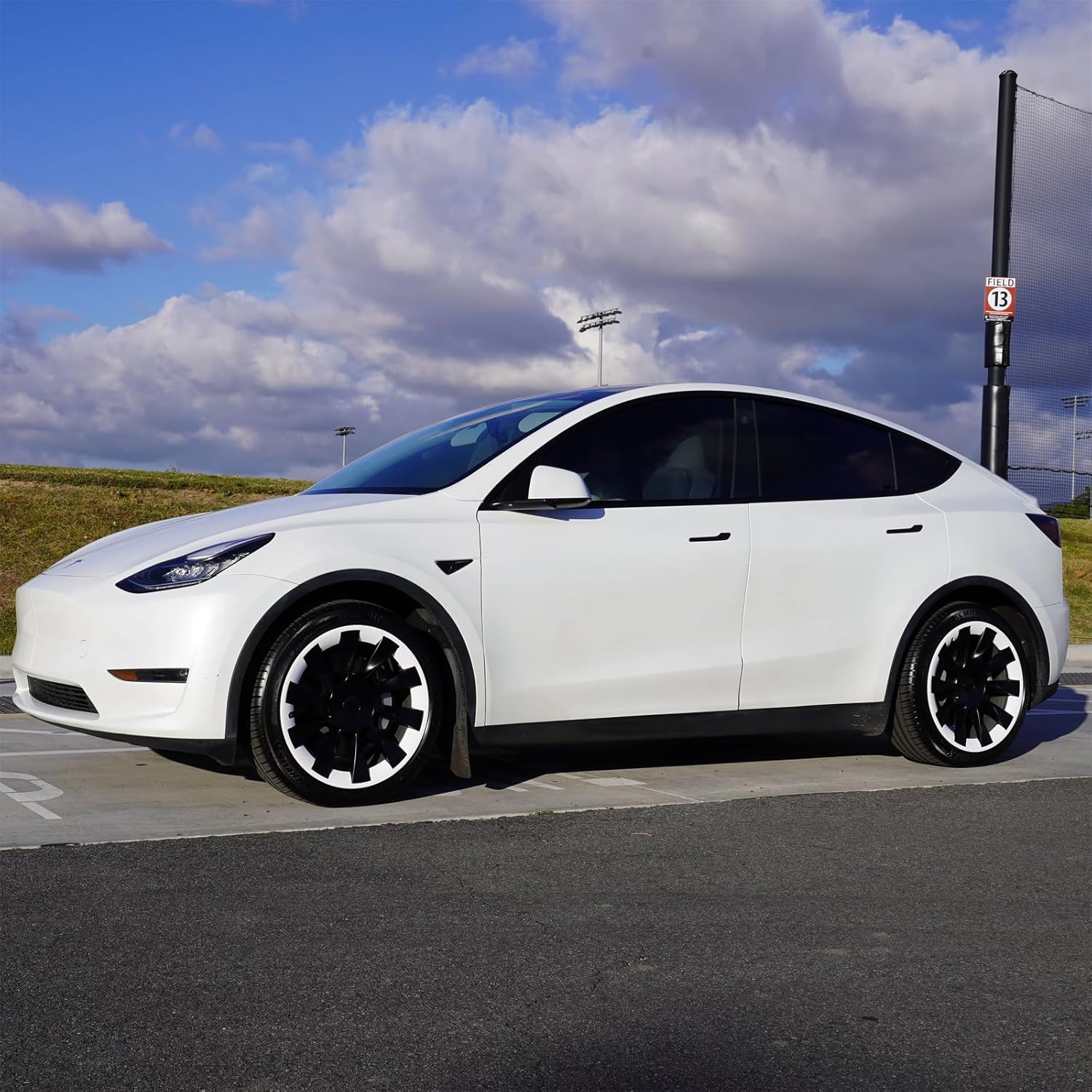 Tesla Model Y 19" 20" Rim Protector Hubcaps installed on a white Tesla Model Y for added wheel protection