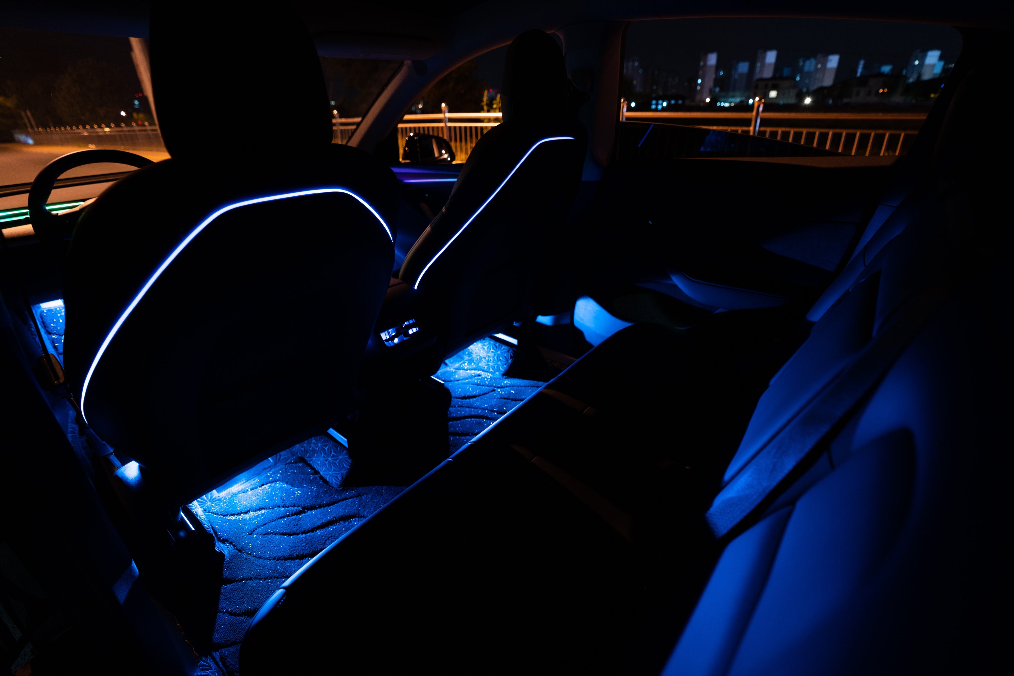 Tesla Model 3 Model Y footwell lights inside car interior at night