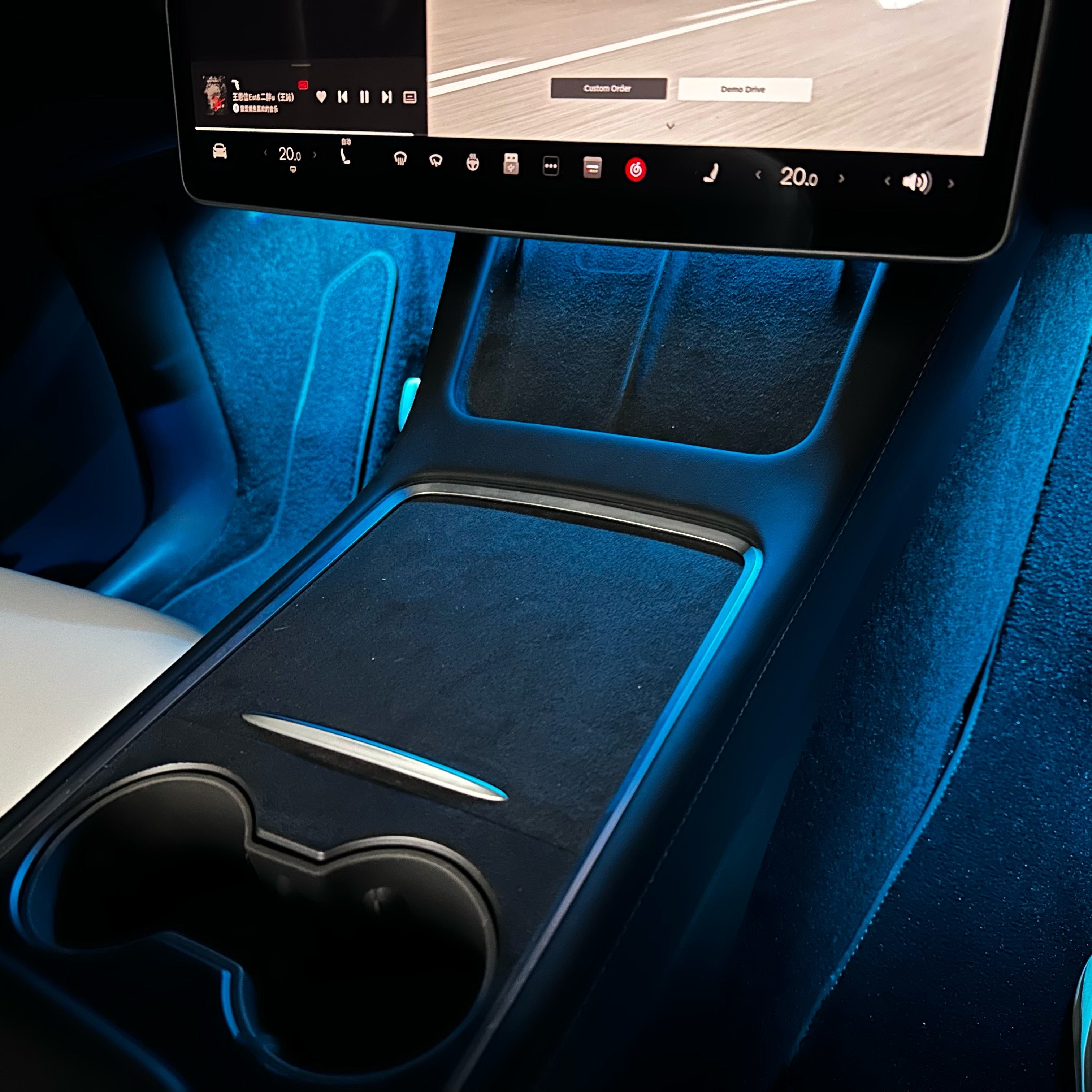 Tesla Model 3 Model Y footwell lights by Lighting Bug illuminating interior center console and floor area