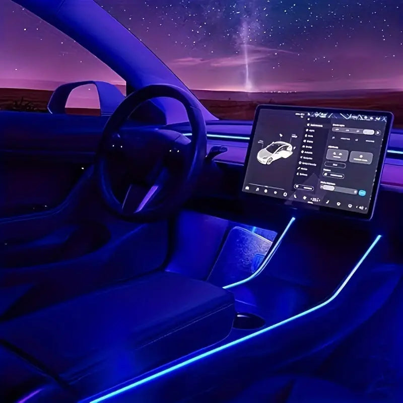 Tesla Model 3 interior with ambient blue LED lighting and touchscreen dashboard at night