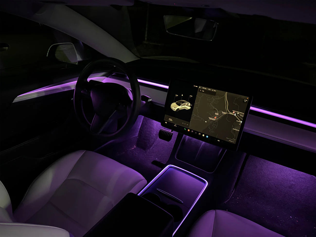 Tesla Model 3 Model Y ambient lighting kit installed showing purple interior LED lights around dashboard and footwell