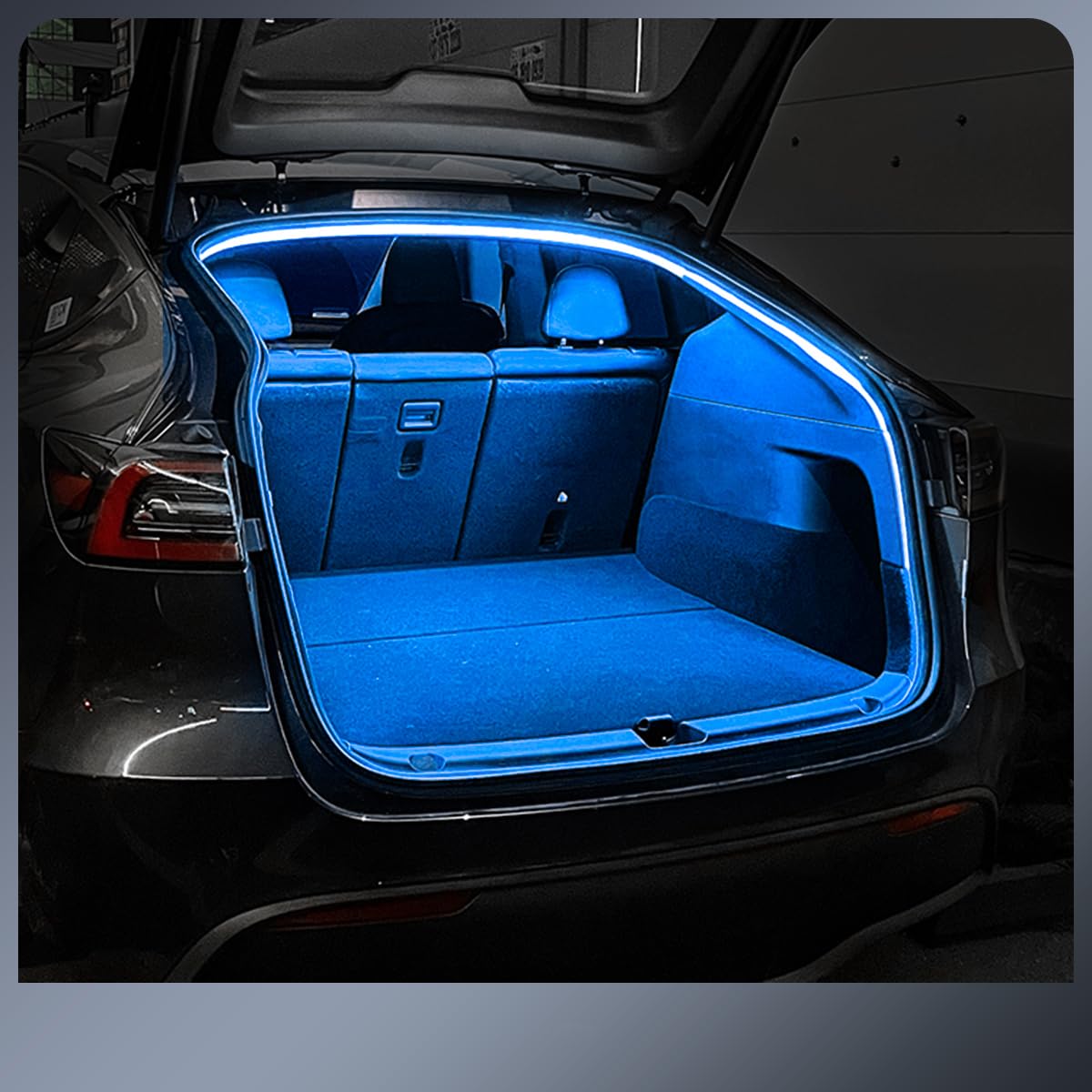 Plug and play Tesla trunk light strip installed glowing blue inside the open trunk of a black Tesla