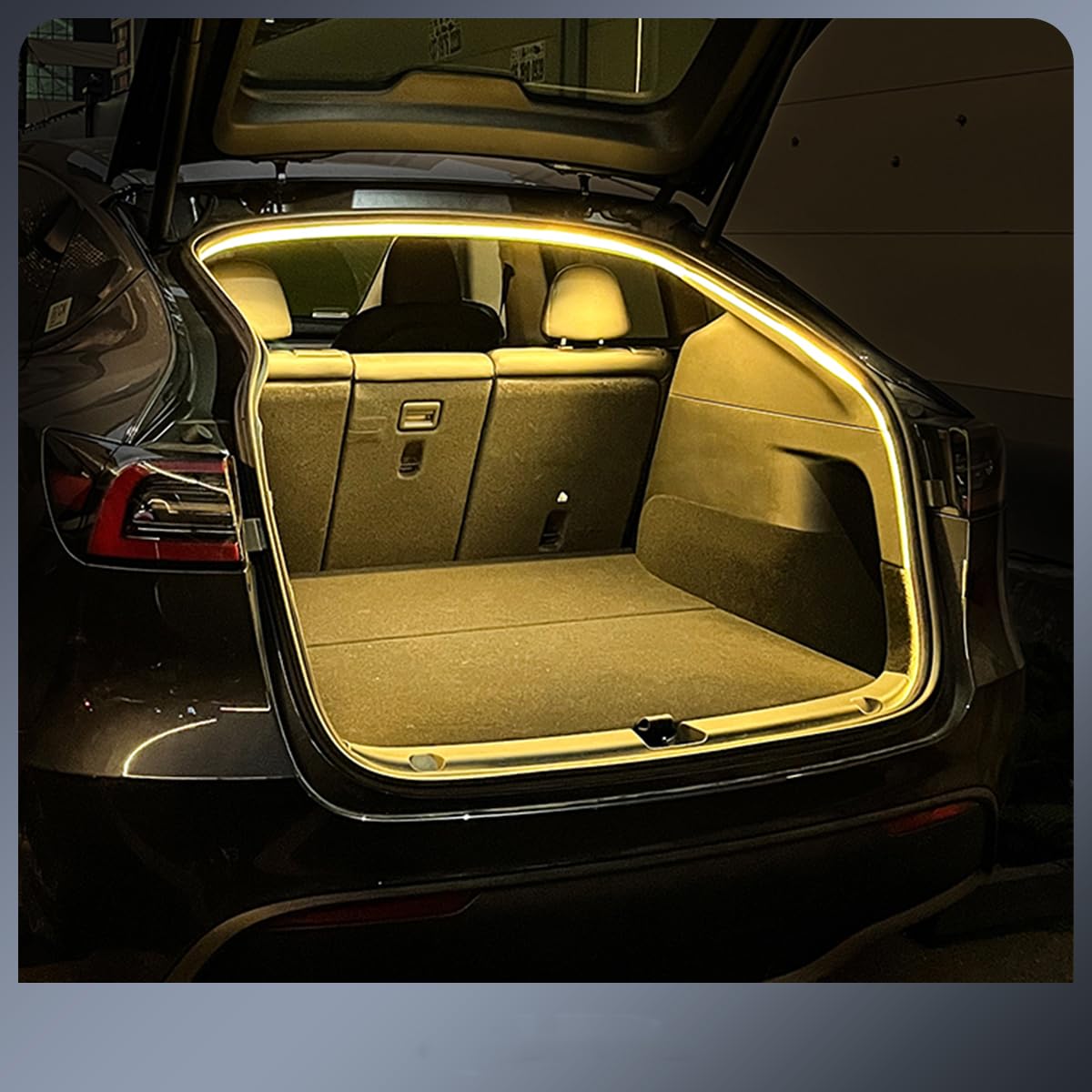 Plug and play Tesla trunk light strip installed inside open Tesla trunk illuminating the cargo area