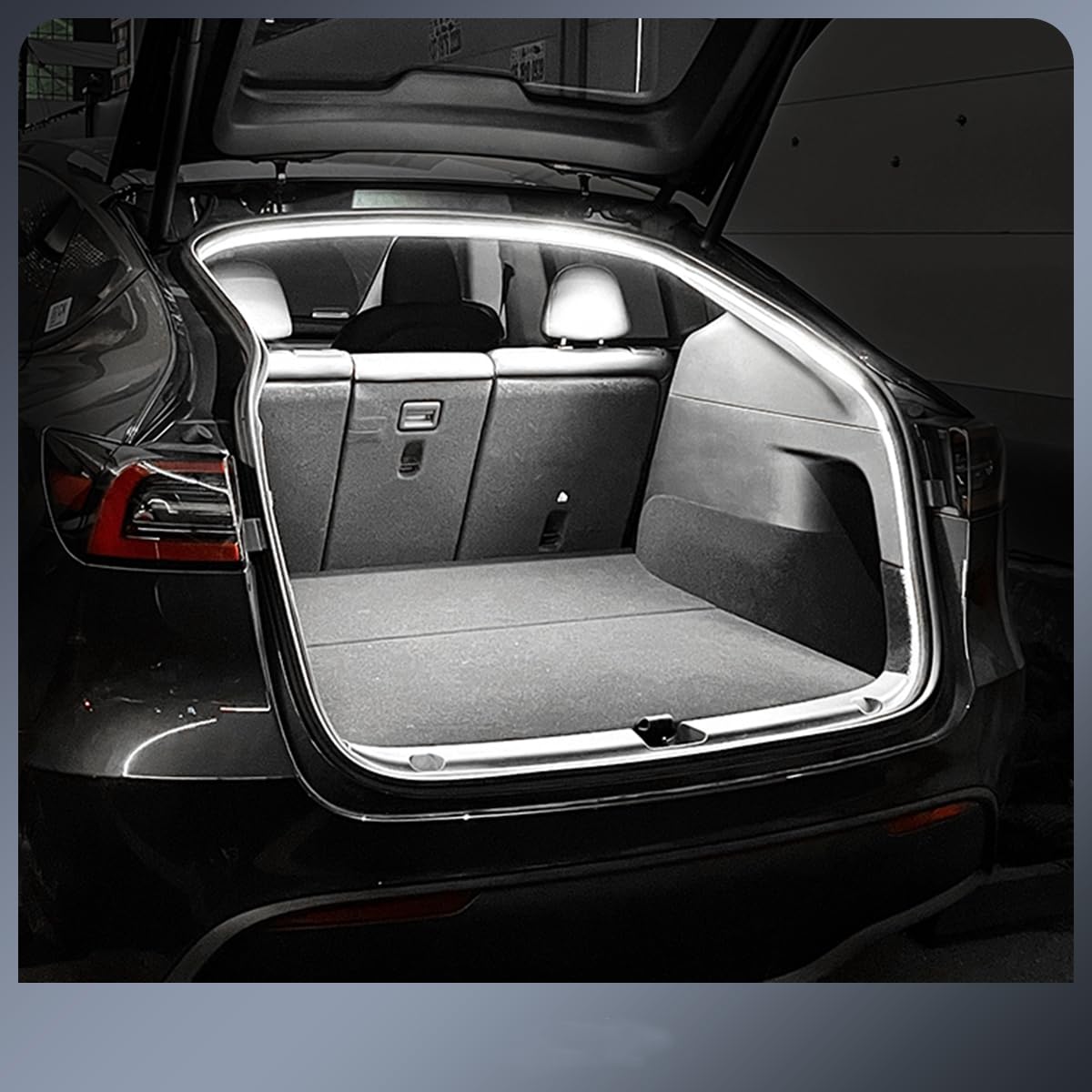 Plug and play Tesla trunk light strip installed illuminating the open trunk of a black Tesla car