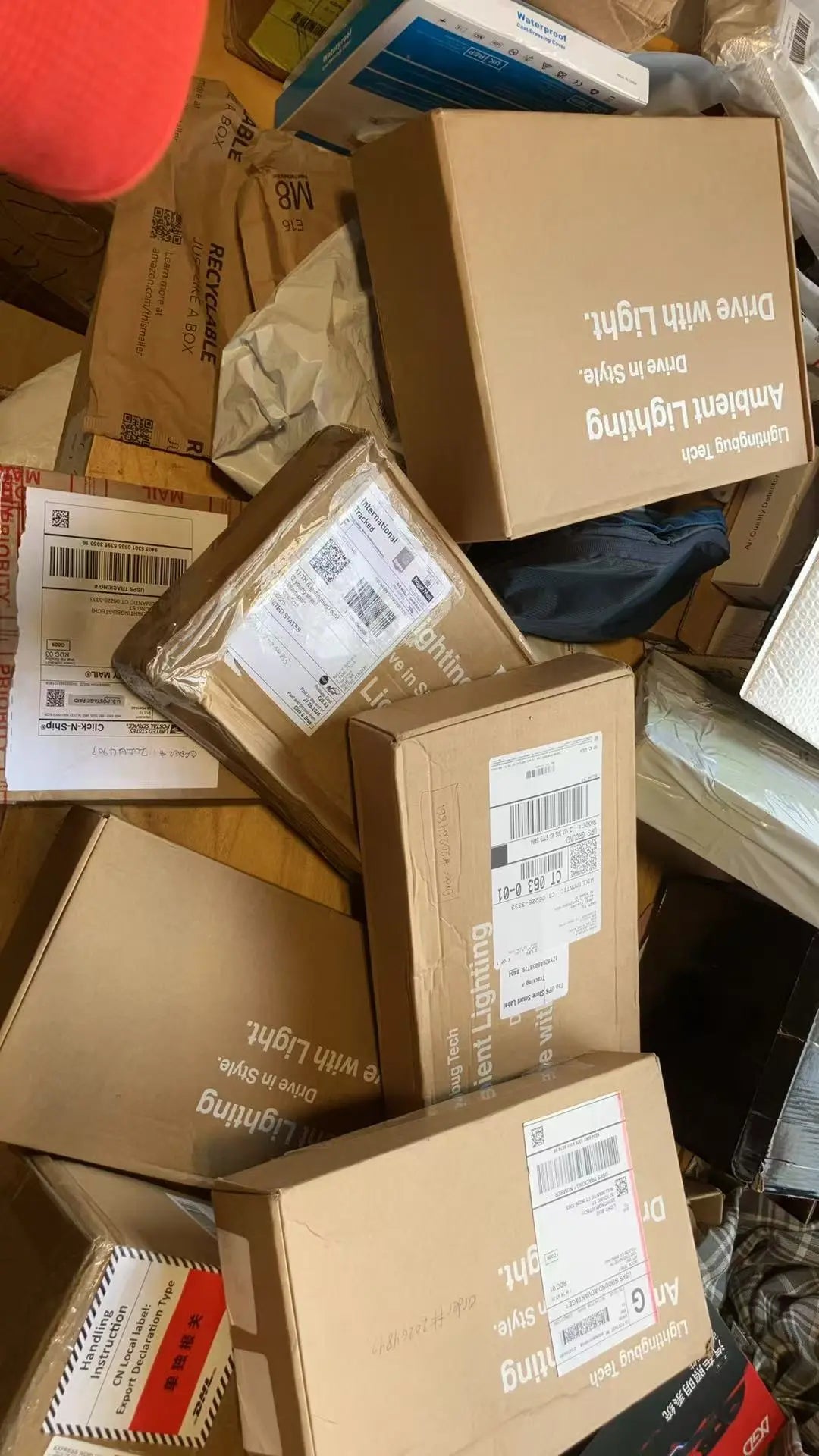Tesla Ambient Lighting Kit boxes stacked on a messy floor with packing materials