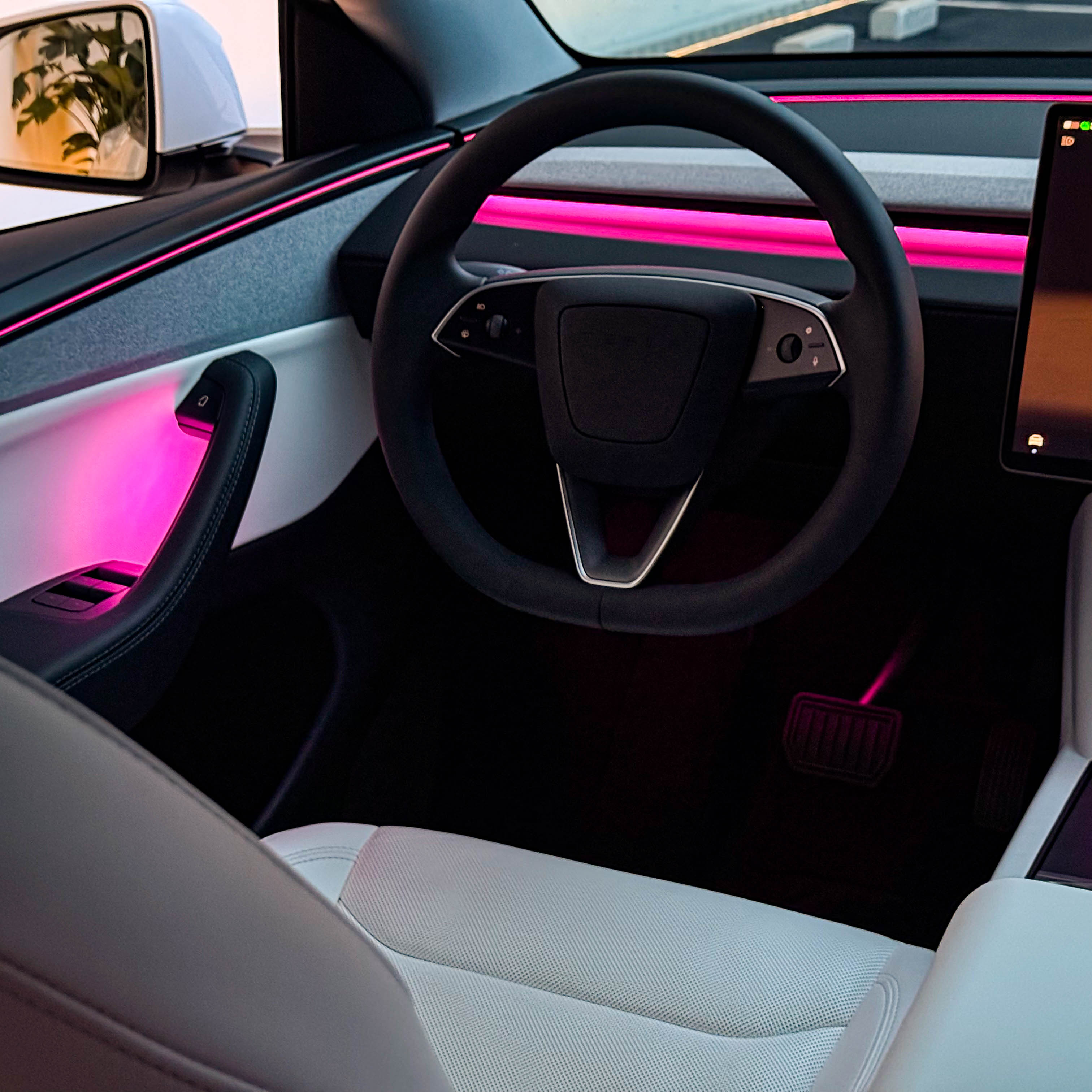 Tesla Highland & Juniper Ambient Lighting Kit inside a modern car interior with vibrant lighting