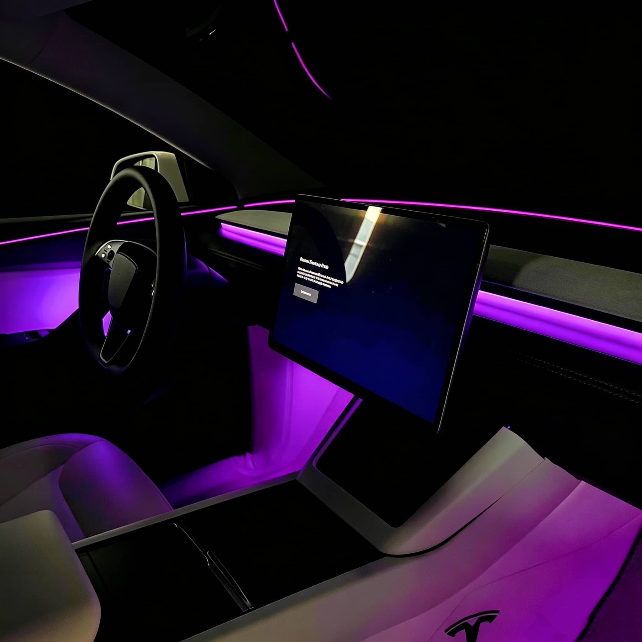 Tesla Highland & Juniper Ambient Lighting Kit illuminating the interior with vibrant purple hues
